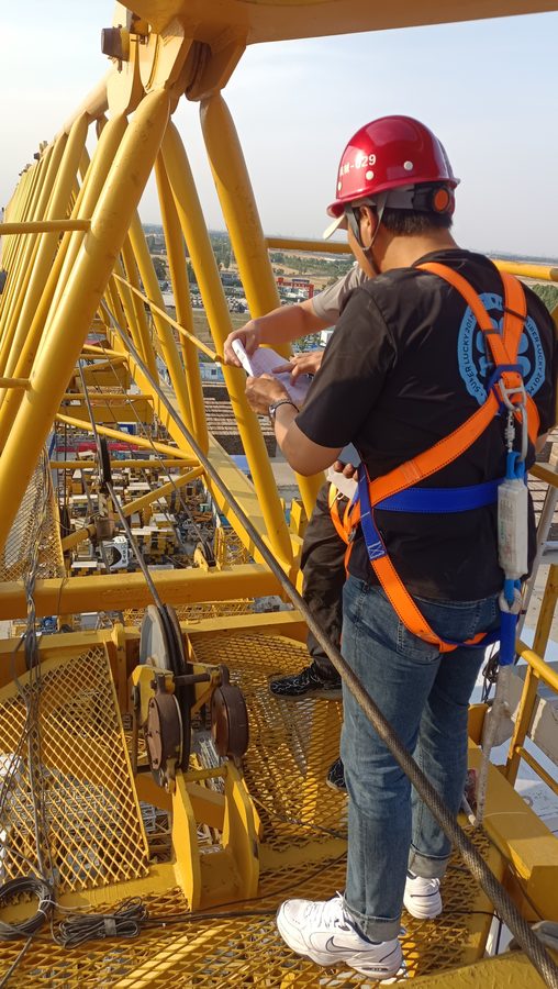 Engineer on a tower crane platform after fitting the safety monitoring unit